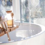hydrated sink in a bathroom with many facial cleansers and soaps.